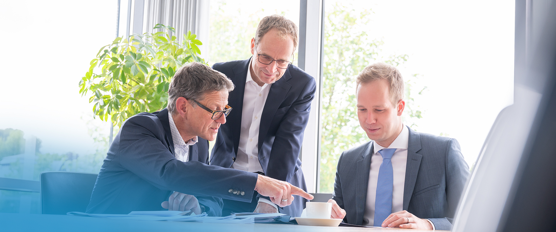 Drei Personen in einer  Gespr�chssituation in der Kanzlei